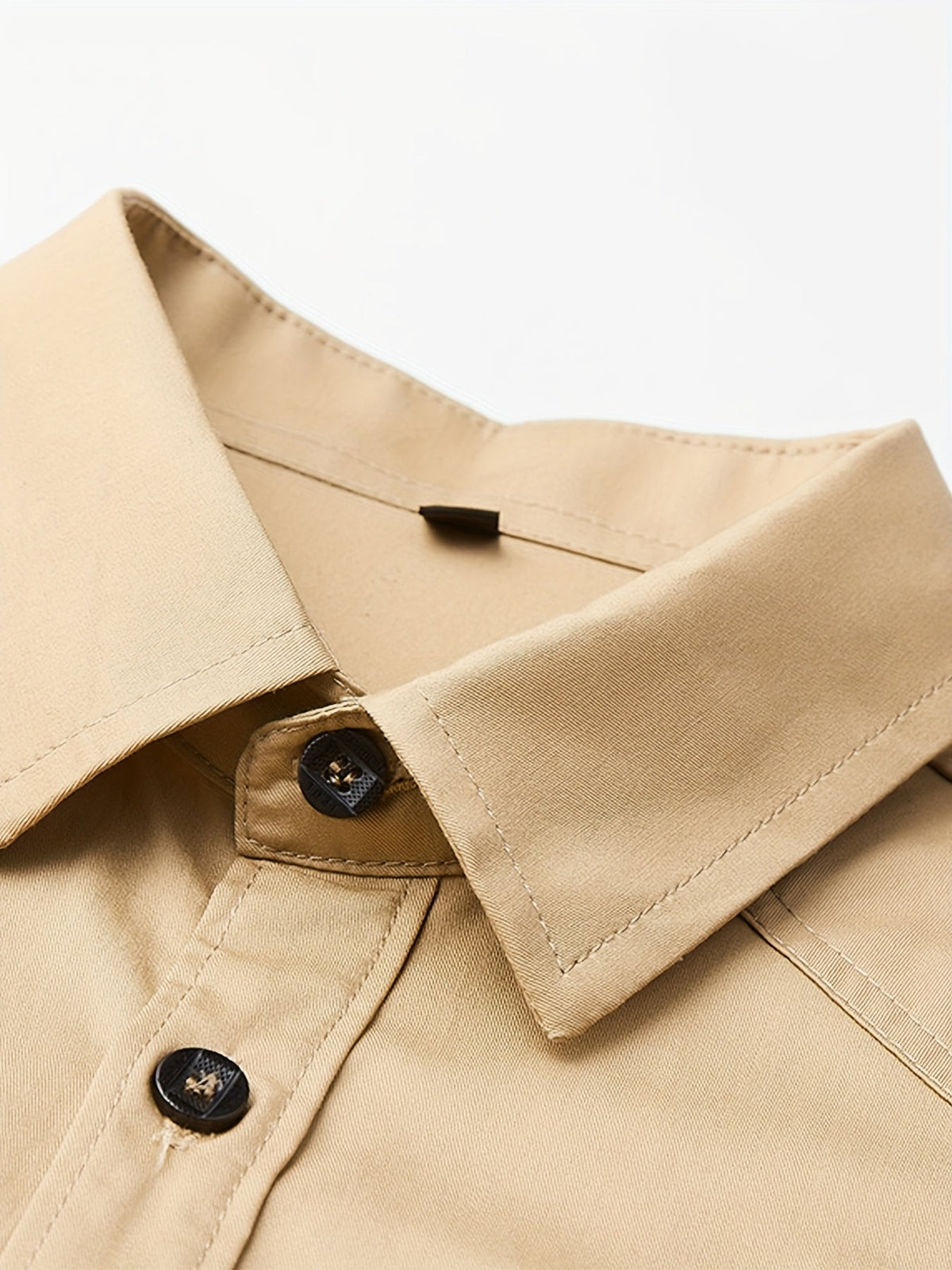 Close-up of Atmora sand beige utility shirt pointed collar, dark buttons and woven fabric