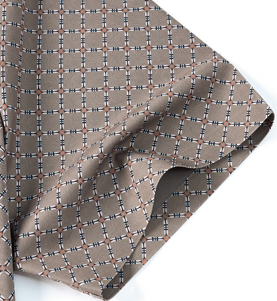 Close-up fabric detail of Atmora taupe beige lattice motif shirt showing imported stretch material and print