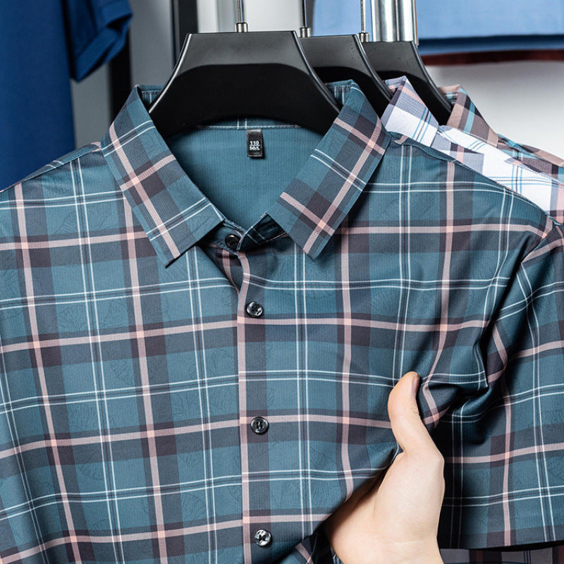 Close-up of Atmora men’s teal slate heritage check short sleeve shirt showing collar and check pattern detail